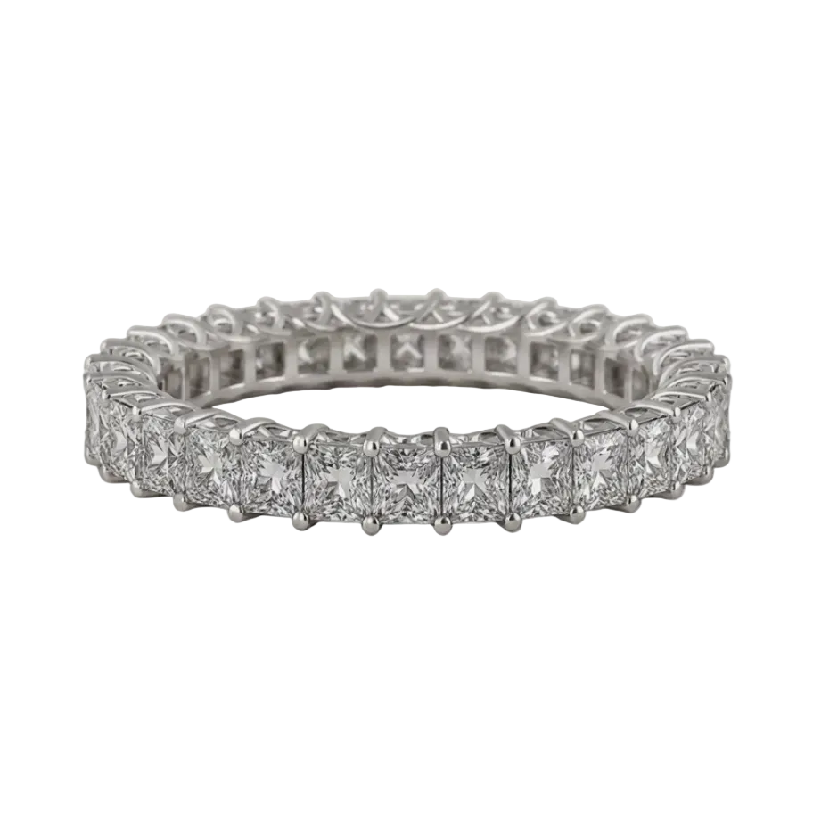 A silver-toned eternity ring featuring a row of princess-cut diamonds in a prong setting, displayed on a textured light beige background.
