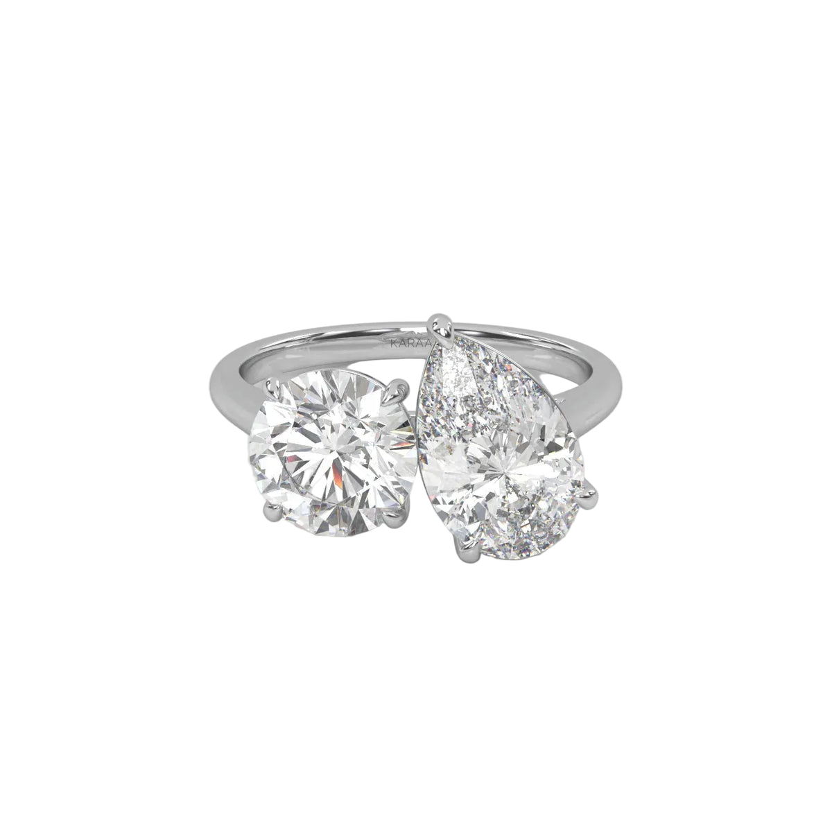 The Round and Pear Toi et Moi ring pairs the timeless brilliance