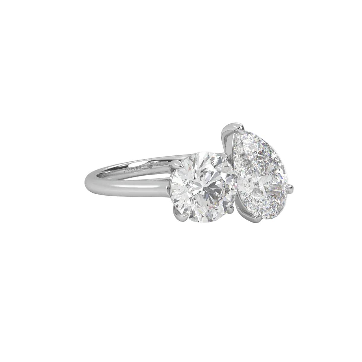 The Round and Pear Toi et Moi ring pairs the timeless brilliance