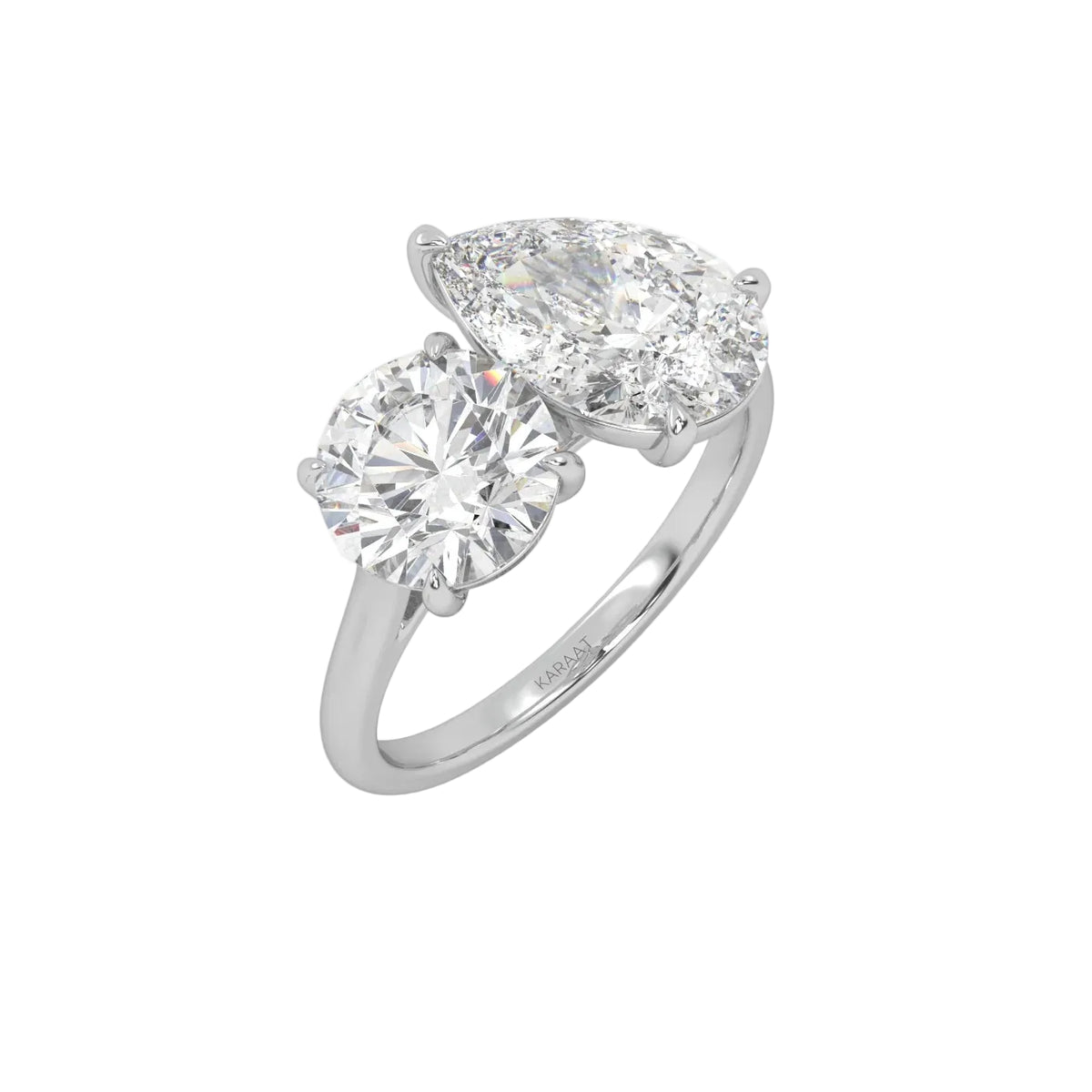 The Round and Pear Toi et Moi ring pairs the timeless brilliance