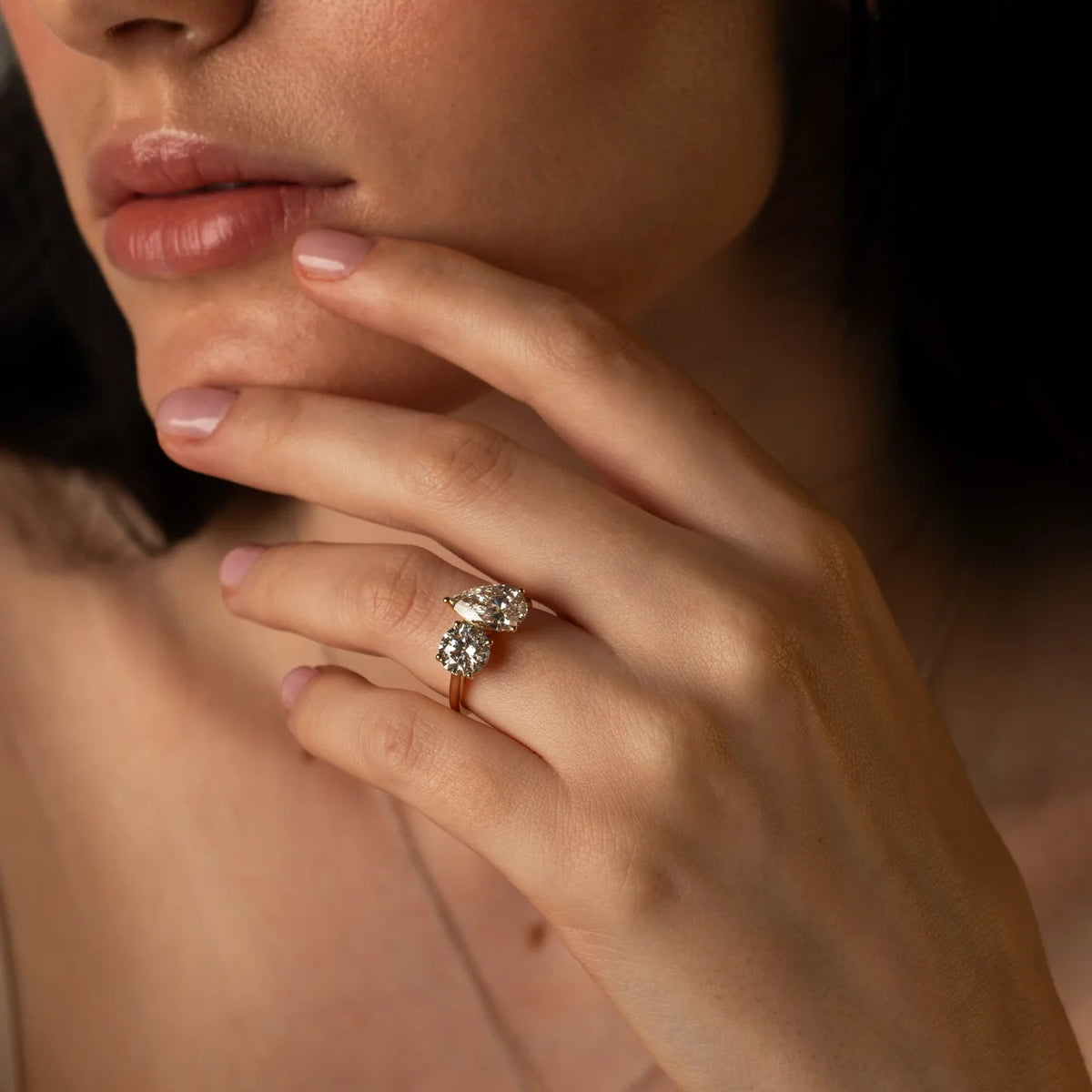 The Round and Pear Toi et Moi ring pairs the timeless brilliance