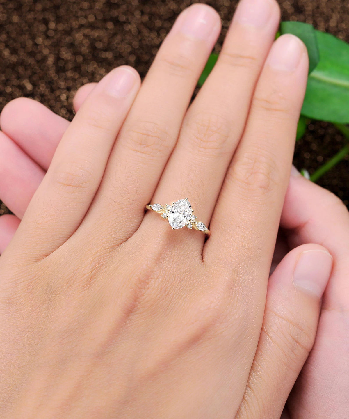 oval lab grown diamond engagement ring in gold, angled view