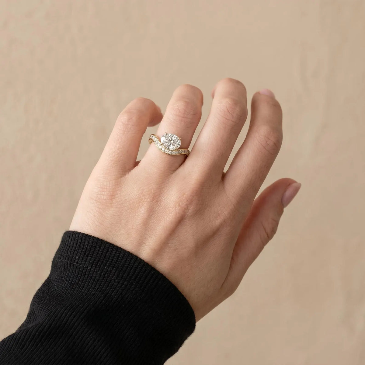 Engagement ring with a 2.90 carat Oval cut solitaire East-West diamond with wave pavé band