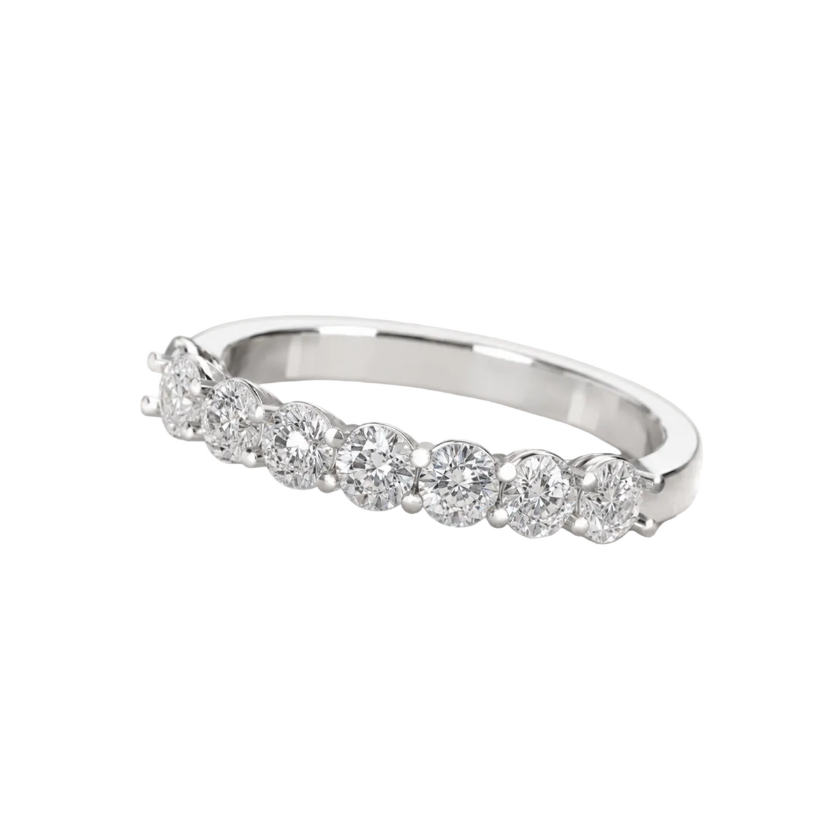 A silver five-stone diamond band ring set on a textured light gray background.