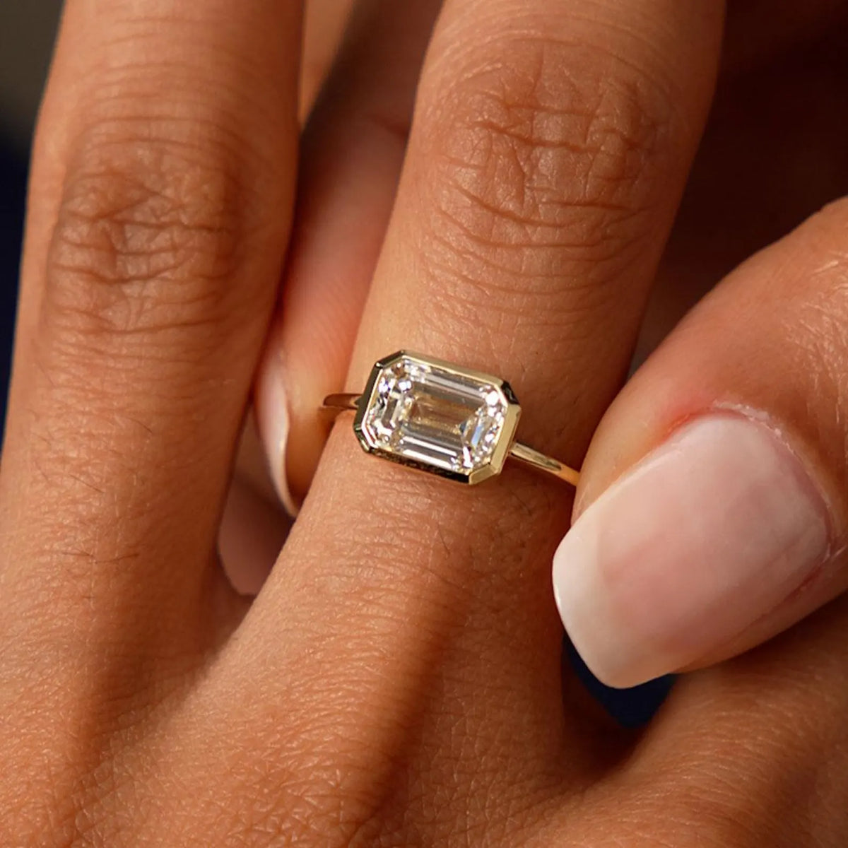 emerald lab grown diamond engagement ring in gold, angled view