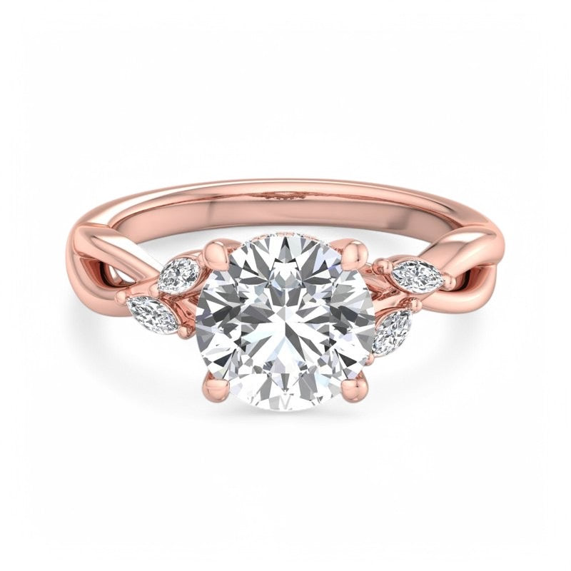 A rose gold engagement ring featuring a round brilliant-cut center diamond and small accent diamonds on a twisted shank, shown on a clean white background.