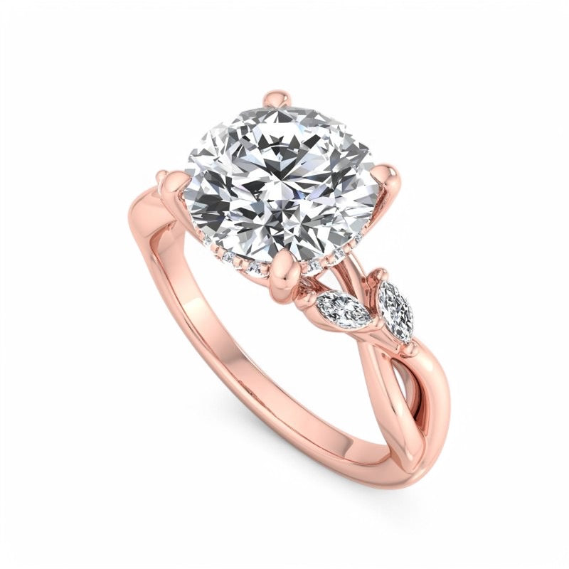 Rose gold engagement ring with a large round-cut clear center stone and two marquise-shaped side stones, shown on a clean white background.