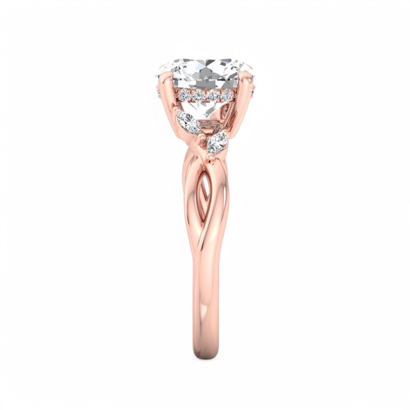 A rose gold engagement ring featuring a round brilliant-cut diamond center stone and smaller accent diamonds along the upper band, set against a plain white background.
