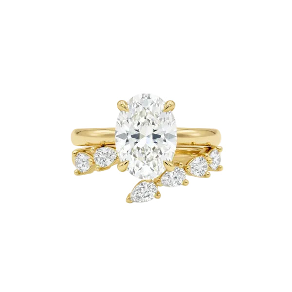 A yellow gold engagement ring featuring a large oval center diamond with marquise-cut side diamonds on a white background.