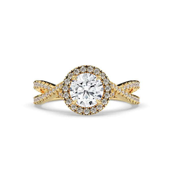 A yellow gold engagement ring featuring a round brilliant-cut center stone surrounded by a halo of small pavé-set diamonds, with a twisted shank also accented by diamonds, set against a plain white background.