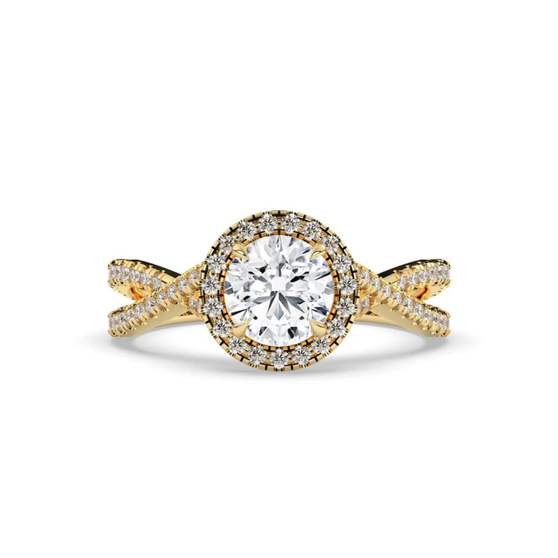 A yellow gold engagement ring featuring a round brilliant-cut center stone surrounded by a halo of small pavé-set diamonds, with a twisted shank also accented by diamonds, set against a plain white background.
