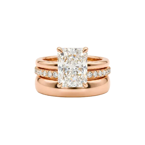 Rose gold ring with a large diamond and smaller diamonds on a white background