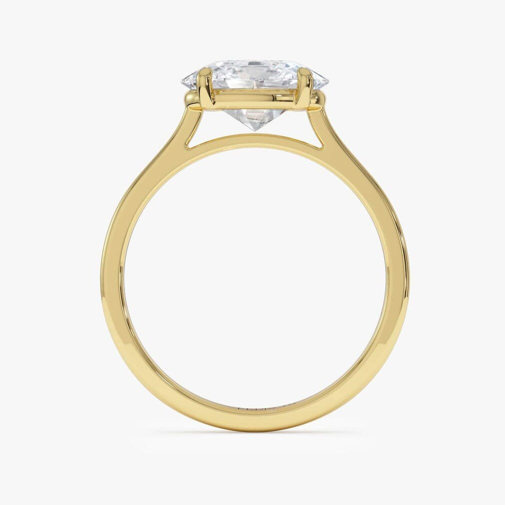 oval lab grown diamond engagement ring in gold, three-quarter view