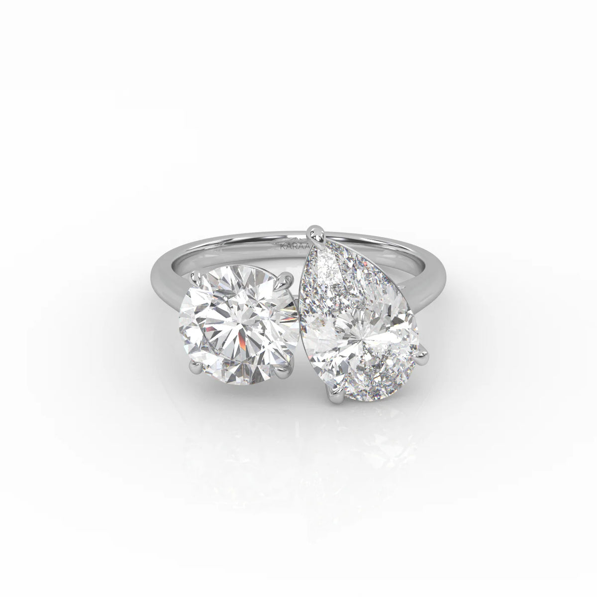 The Round and Pear Toi et Moi ring pairs the timeless brilliance