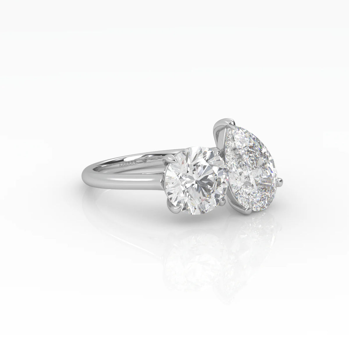 The Round and Pear Toi et Moi ring pairs the timeless brilliance