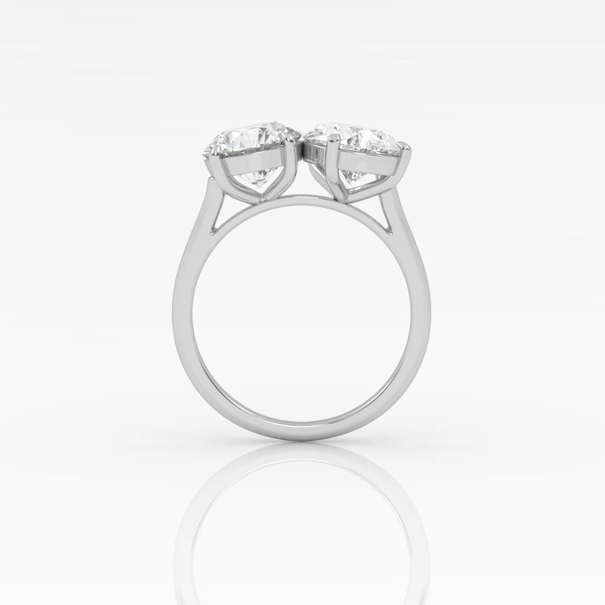 The Round and Pear Toi et Moi ring pairs the timeless brilliance