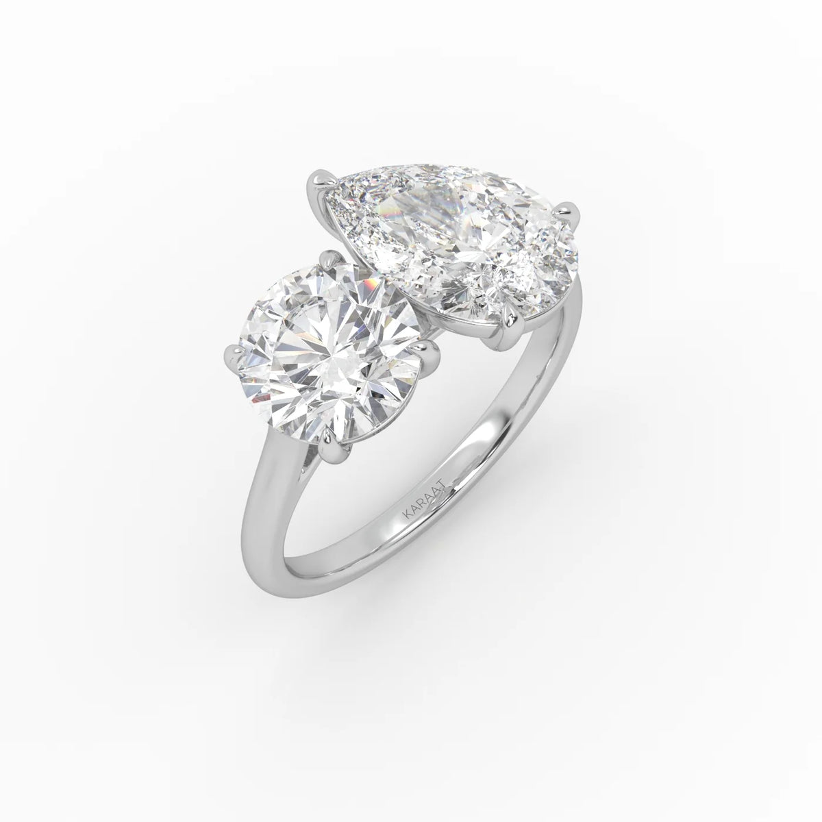 The Round and Pear Toi et Moi ring pairs the timeless brilliance
