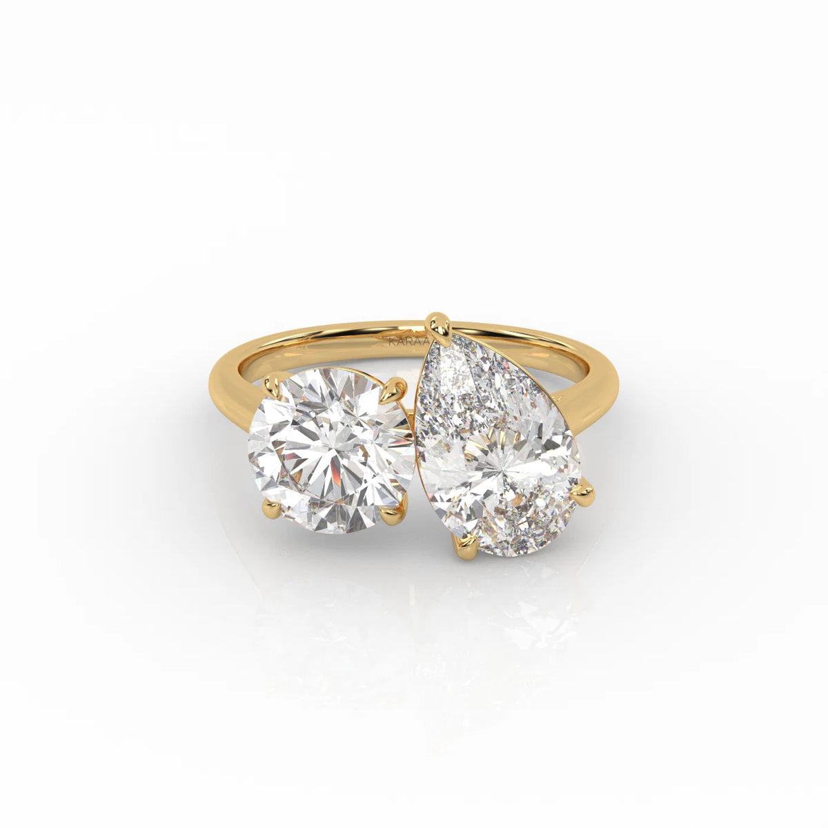 The Round and Pear Toi et Moi ring pairs the timeless brilliance