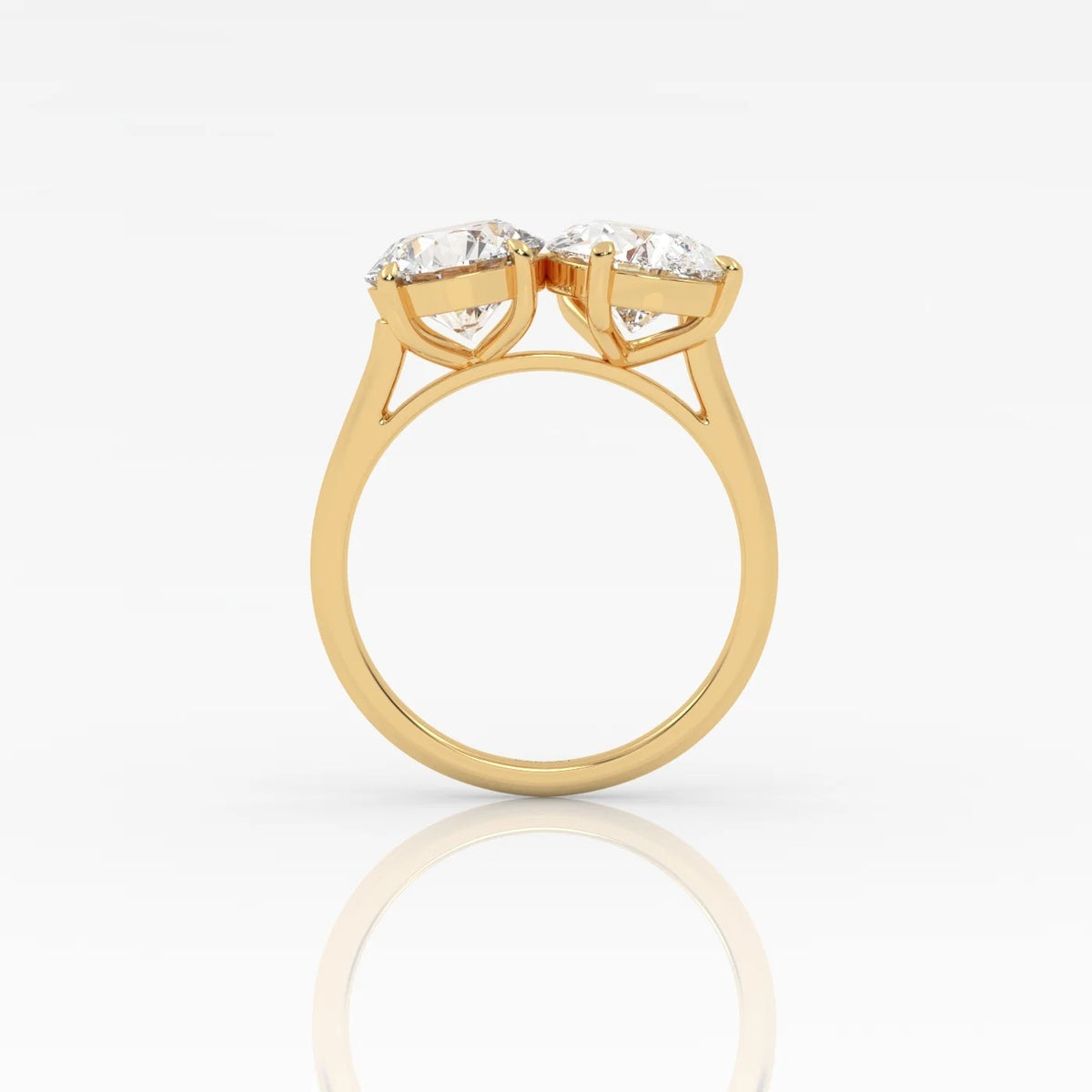 The Round and Pear Toi et Moi ring pairs the timeless brilliance