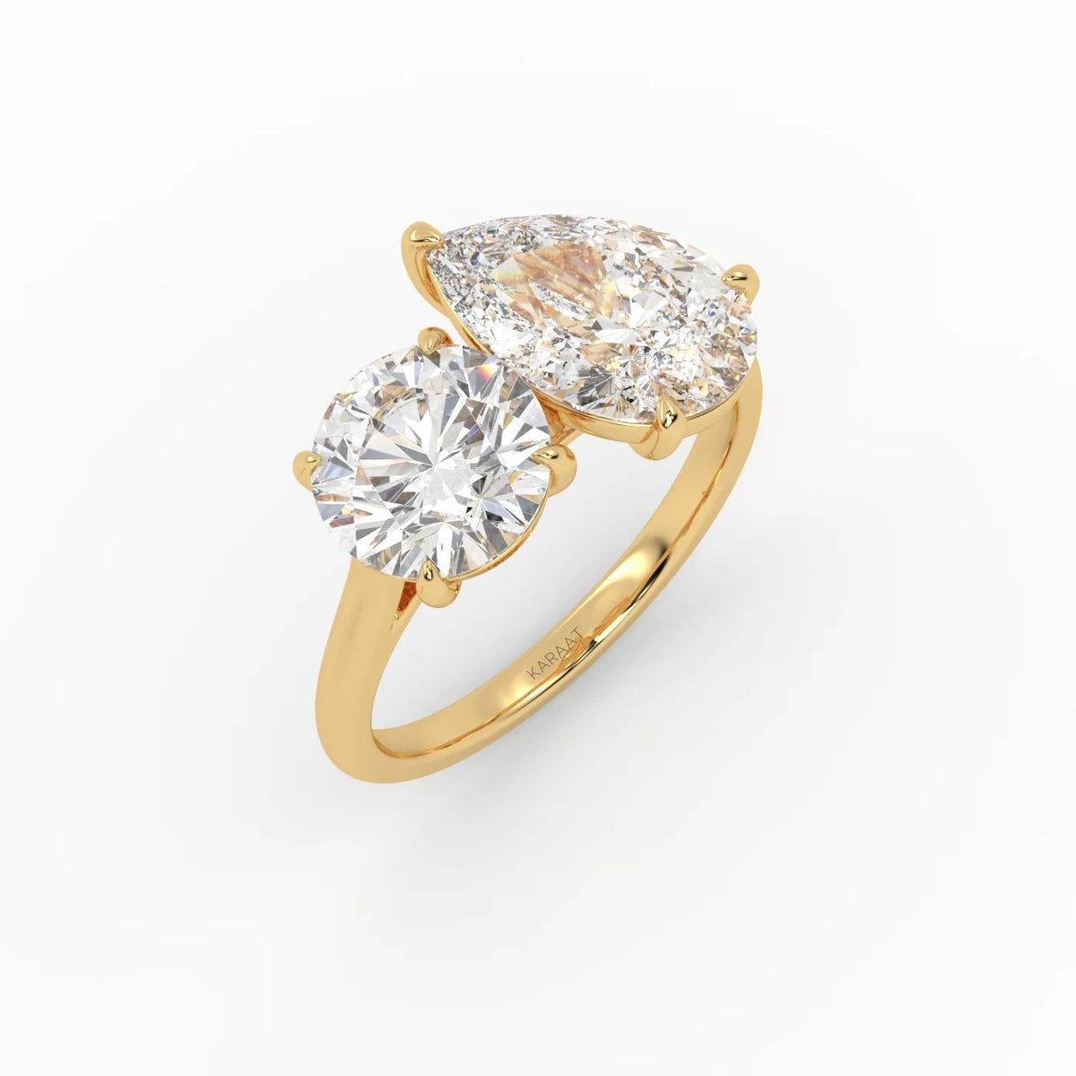The Round and Pear Toi et Moi ring pairs the timeless brilliance