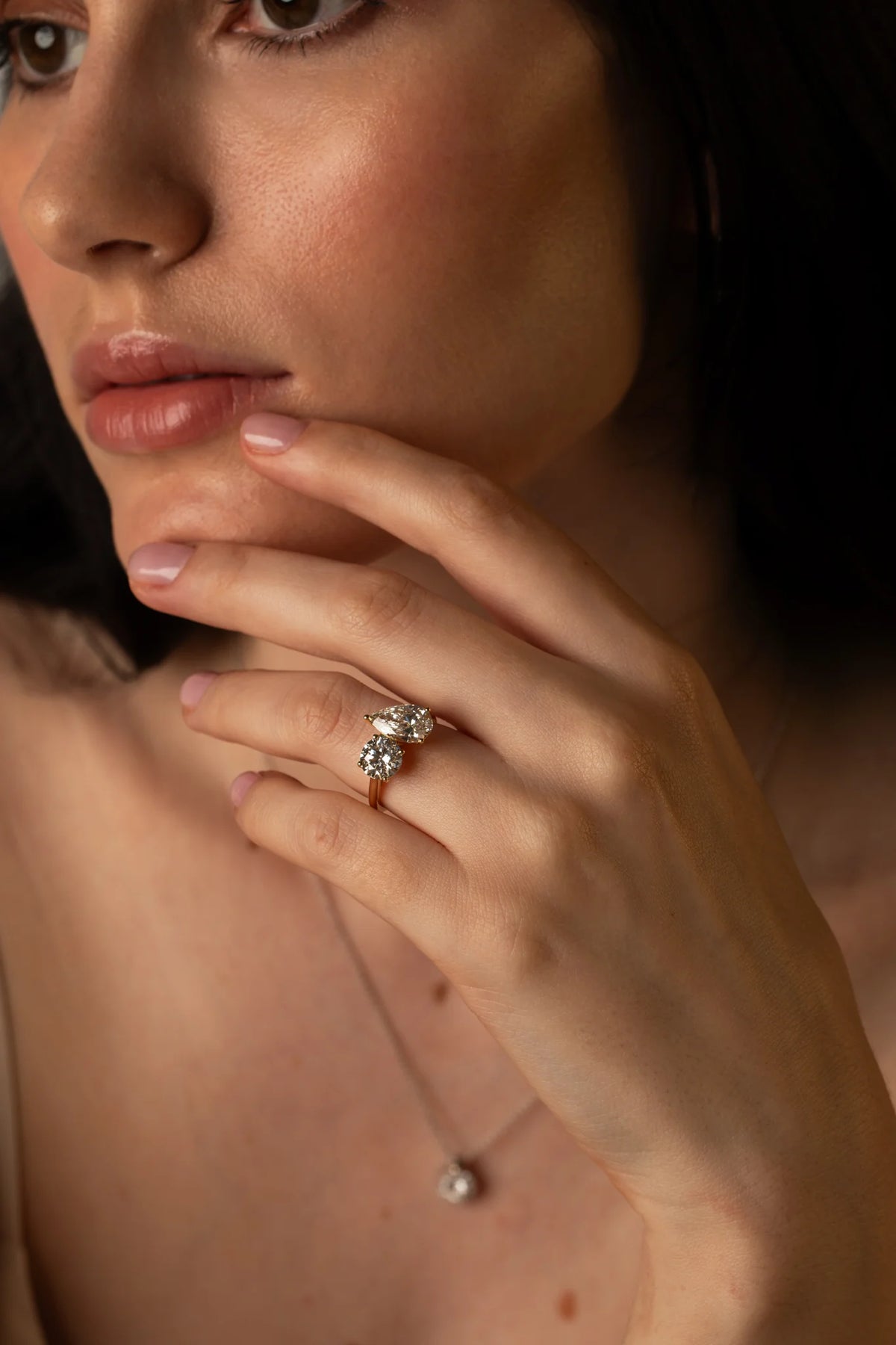 The Round and Pear Toi et Moi ring pairs the timeless brilliance