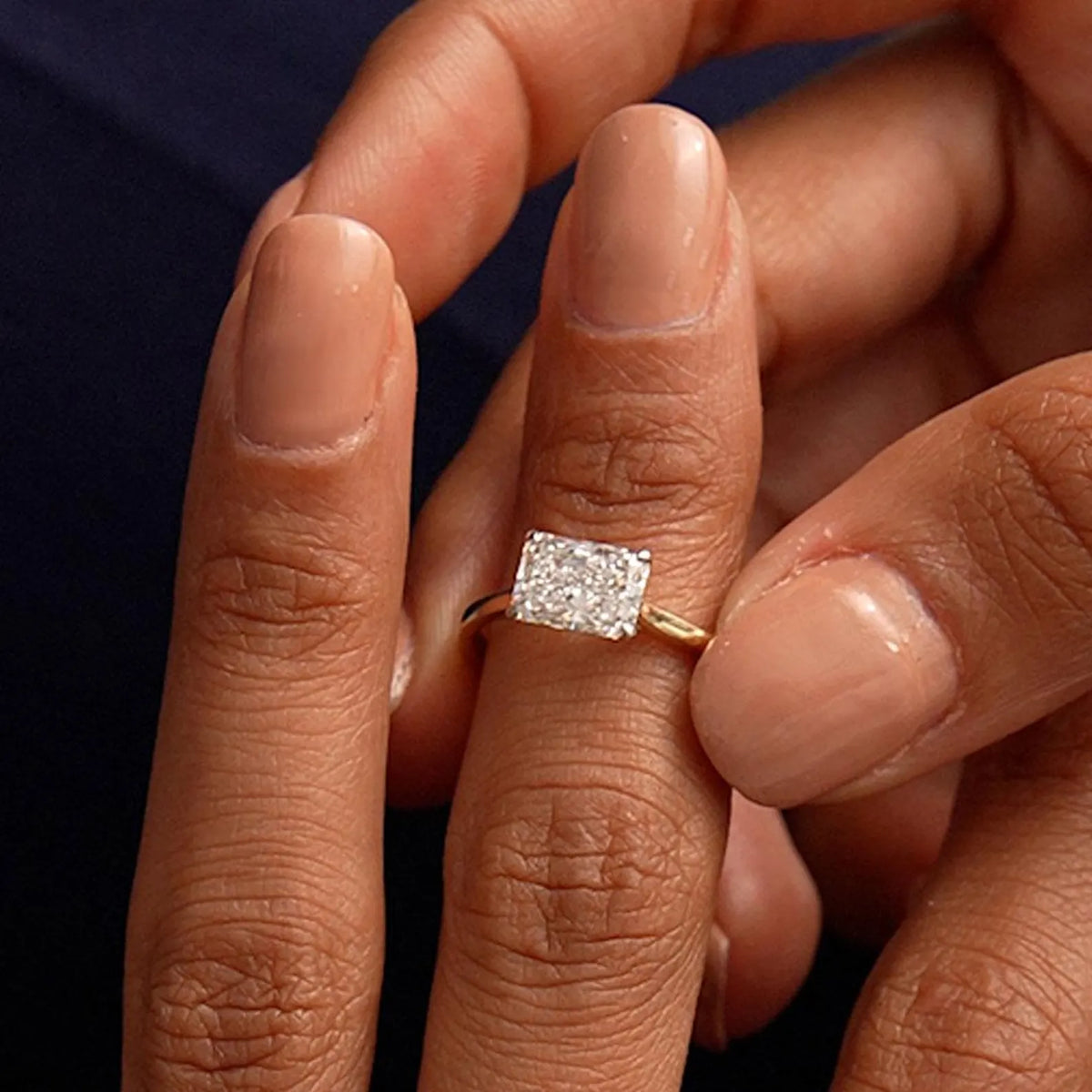 radiant lab grown diamond engagement ring in gold, angled view