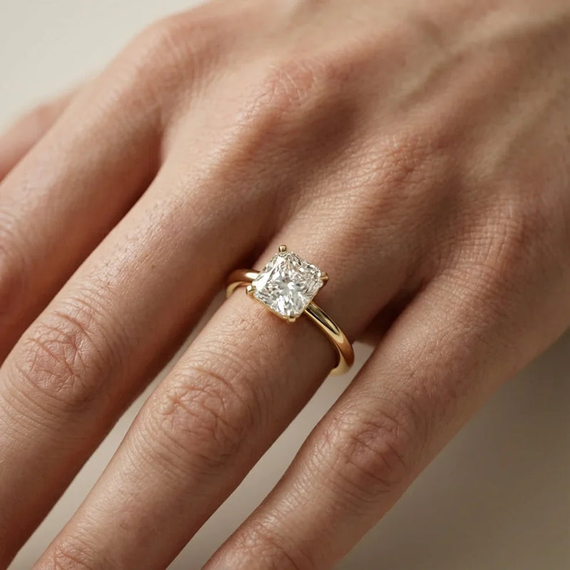 emerald lab grown diamond engagement ring in silver, three-quarter view