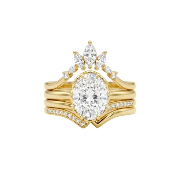 A yellow gold bridal stack set featuring an oval-cut center diamond ring, a marquise-shaped diamond pendant, and smaller accent diamonds on the bands, shown on a clean white background.